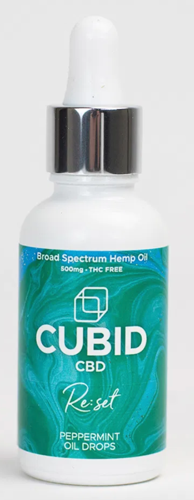 A bottle of peppermint Cubid CBD with a blue label