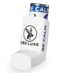 A white inhaler with a logo of a wasp on in it in black. There is a blue top with the words BE CALM on there. The logo CBD LUXE is in block capitals on the front of the inhaler