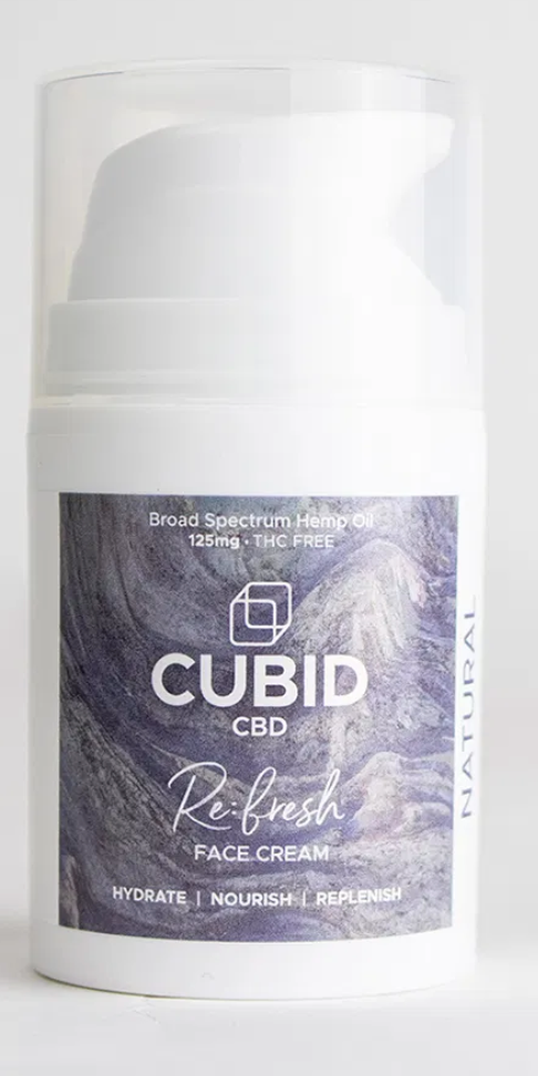 A bottle of cubid CBD face cream on a white background