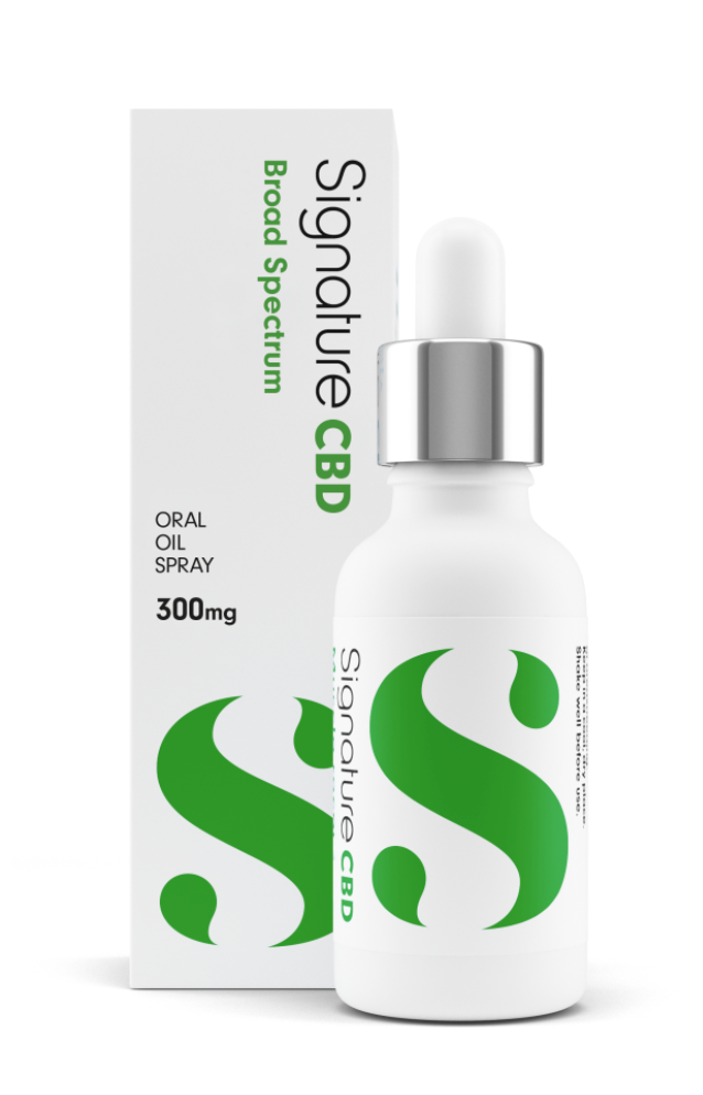 A white bottle of signature CBD with green lettering stands next to the packaging.