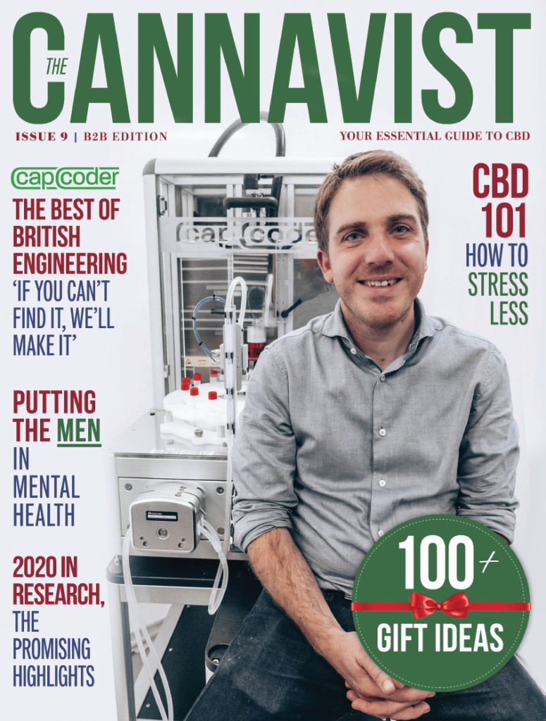 The cover of a magazine, with red, green and white colours features a man in a grey shirt and some text. 