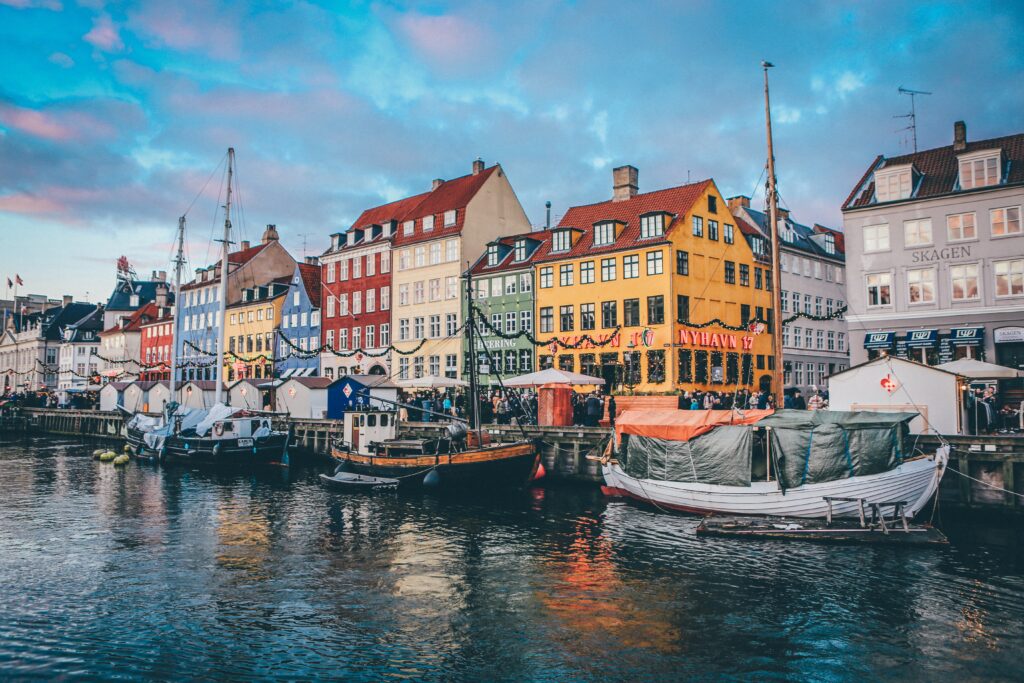 A shot of the colourful houses lining the main canal in Denmark and the boats there