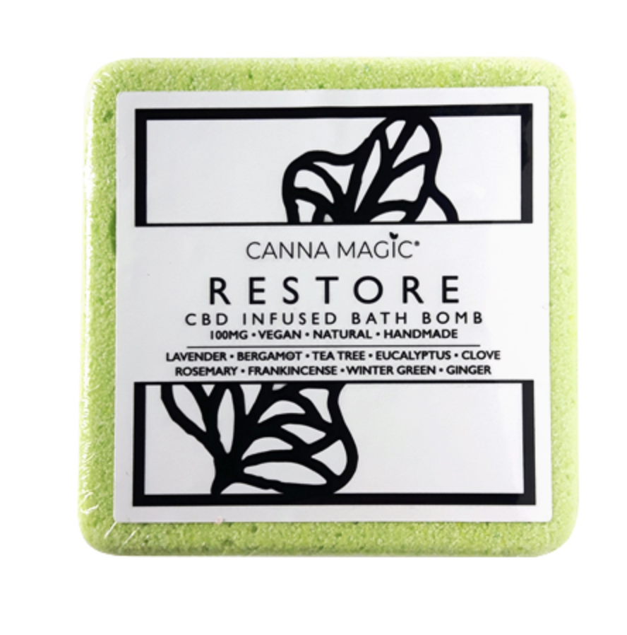 A green square bath bomb with RESTORE written in capital letters on the label from Canna Magic.