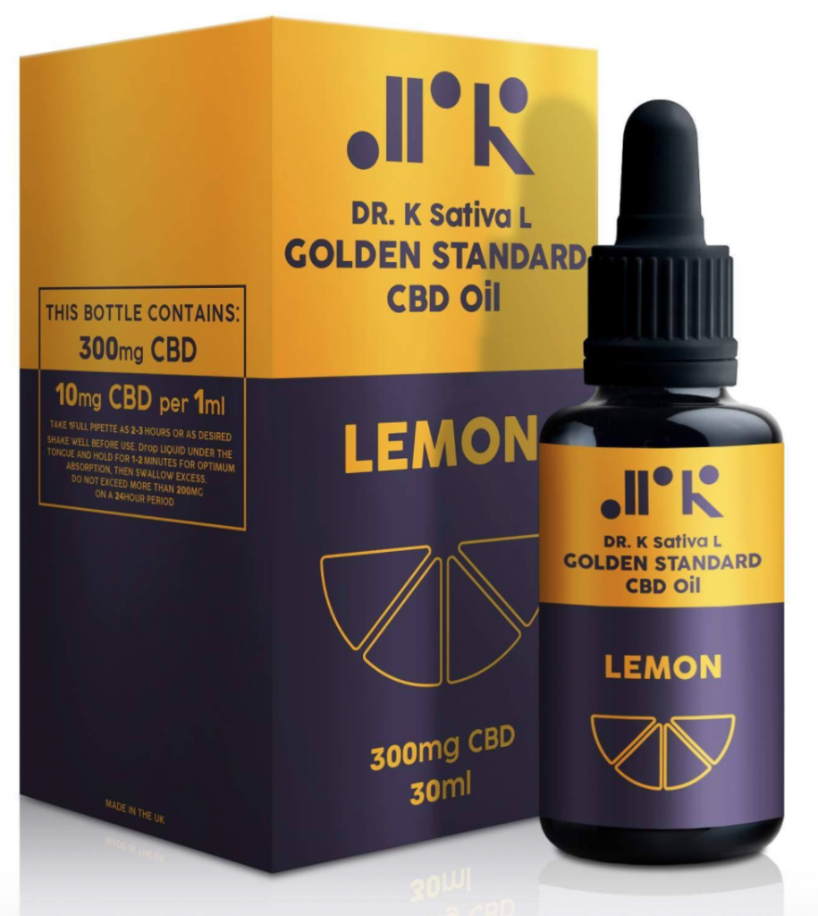 A bottle of purple and yellow CBD oil with lemon flavour stands in front of the box