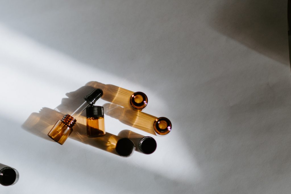 Small brown bottles with a oil dropper on a white background