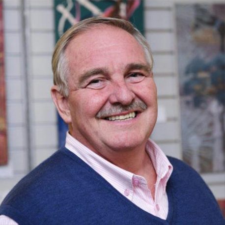 A gentleman smiles while facing the camera for a photograph