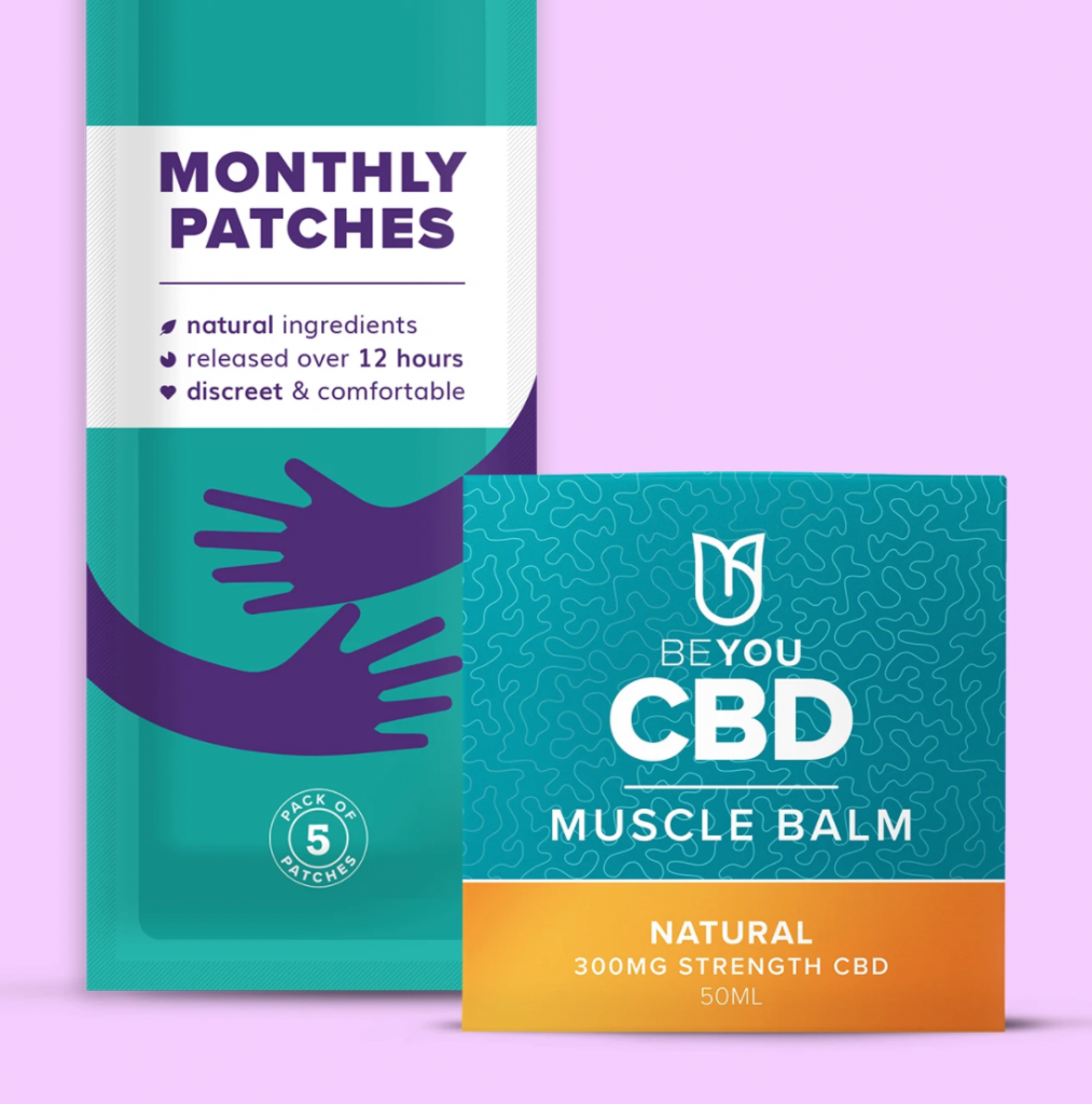 A packet of monthly patches in. ablue colour near a smaller square box of CBD muscle balm
